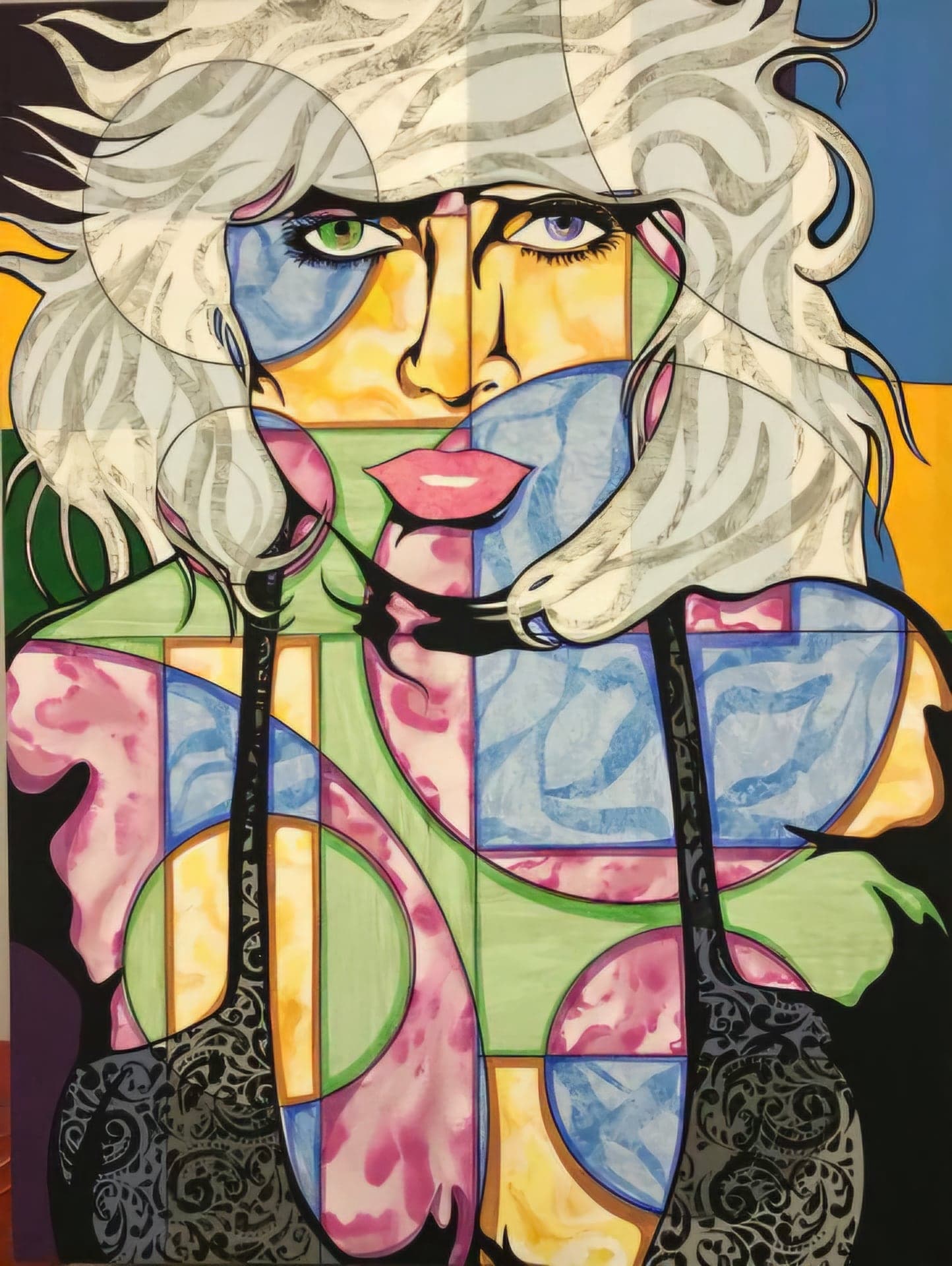 A blonde face set against a grid of pastel blue, pink and yellow shapes.
