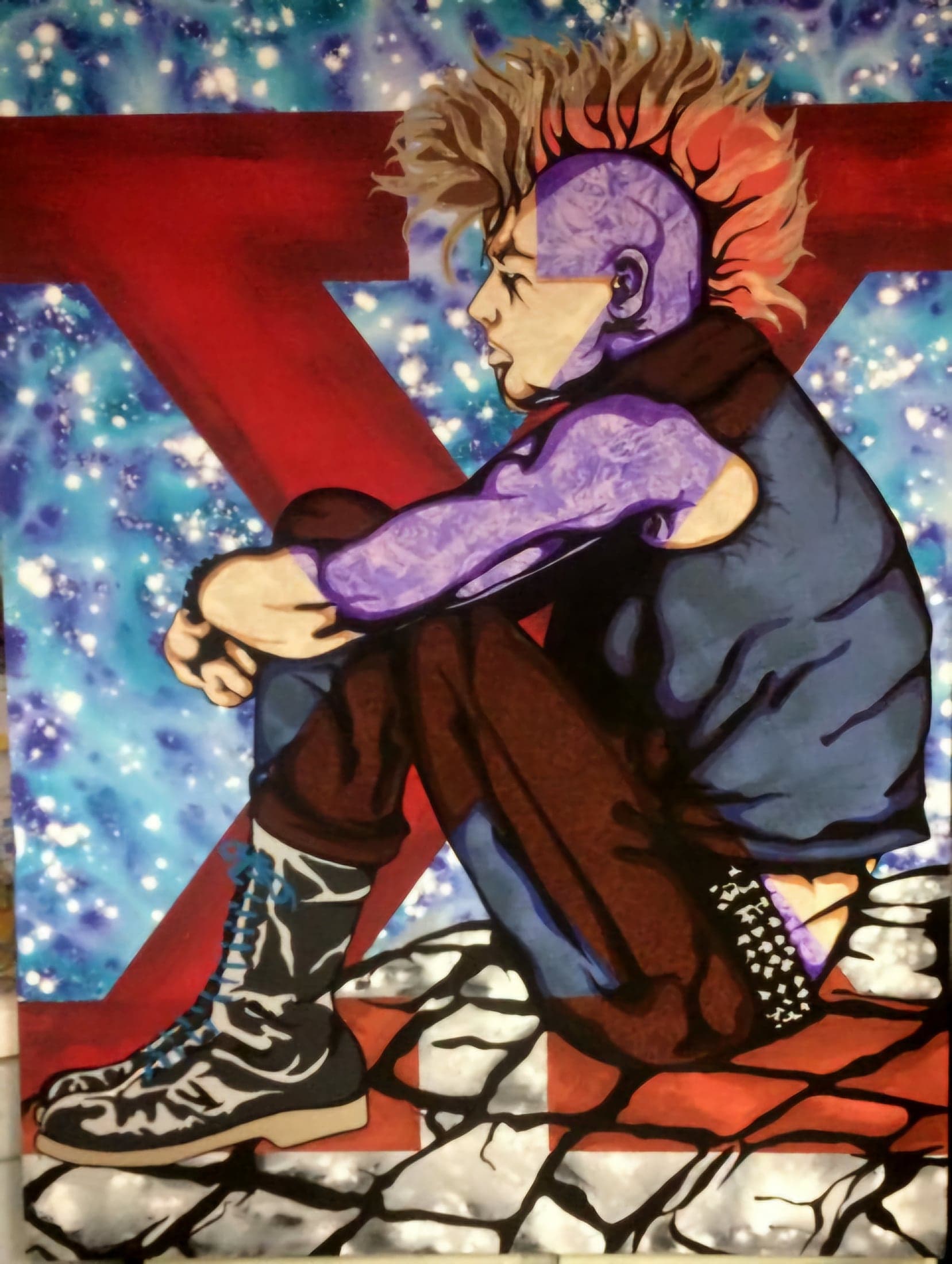 A seated figure with a mohawk and heavy boots, knees drawn up, against a red X and a starry ground.